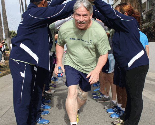 Back on My Feet - photo of man running through crowd